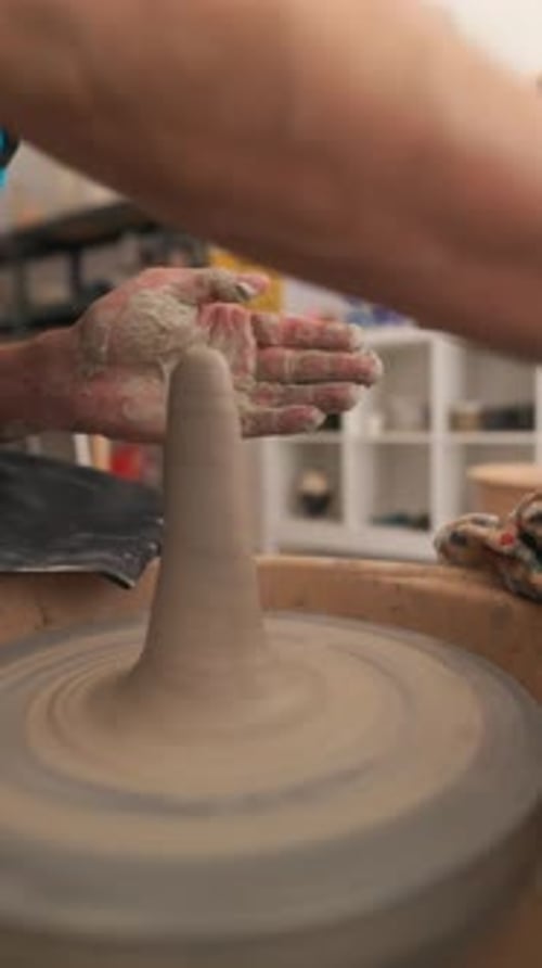 Potter Shaping Clay on a Spinning Pottery Wheel