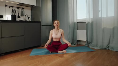 Woman Doing Yoga in Kitchen at Home