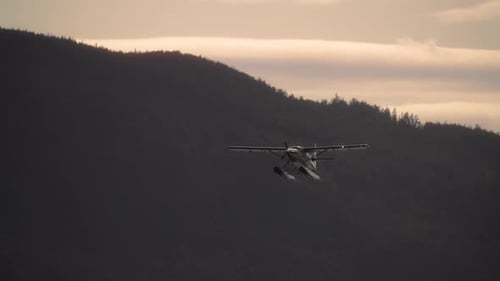Seaplane flying with mountain hills and sunset in the background