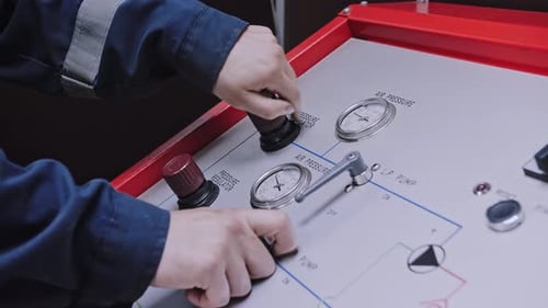 A Worker Turns on a Pressure Sensor at the Factory Hands are Large