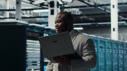 Server Room Worker Auditing Systems for Vulnerabilities Using Software on Laptop