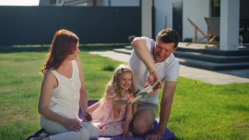 Family Plays With Drone On Suburban Lawn