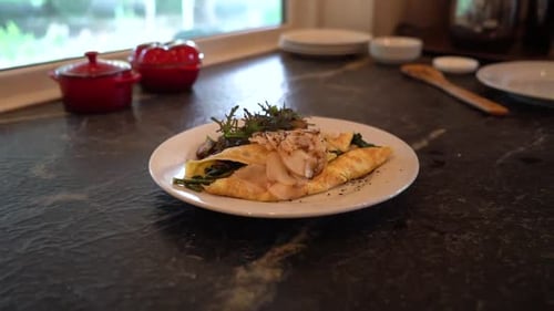 Omelet on Marble Countertop with Greens and Meat