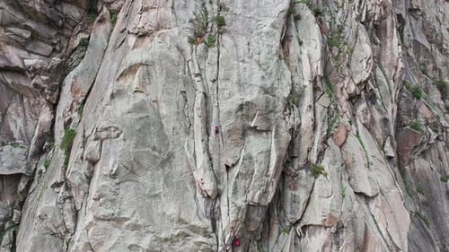 Climbers Make Their Way Up a Steep Rock Face