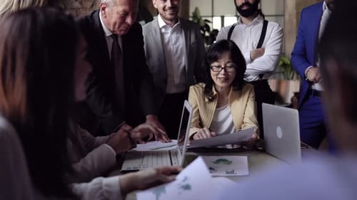 Multiracial business group of people working on financial strategy inside bank office