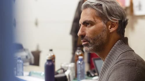 Man With Gray Hair Talking Indoors Close Up