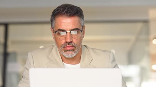 Trader Broker Investor Analyzing Stock Trade Market in Glasses with Reflection