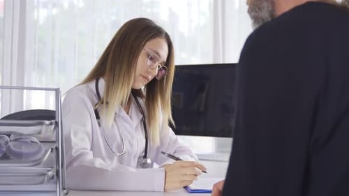 Doctor Consulting with Patient in Medical Office