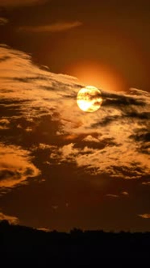 Golden Sun Rising Through Clouds in Time-Lapse