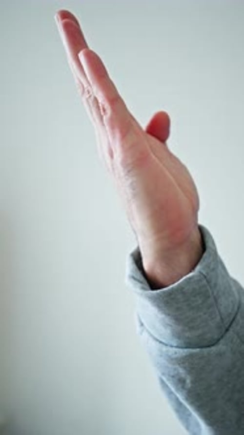 Adult Male Hand Making Gestures Against Plain Background