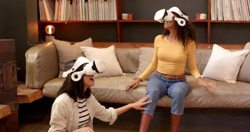 Smiling Women Play with VR Headsets Indoors
