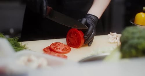 Slicing Fresh Tomato in Restaurant Kitchen