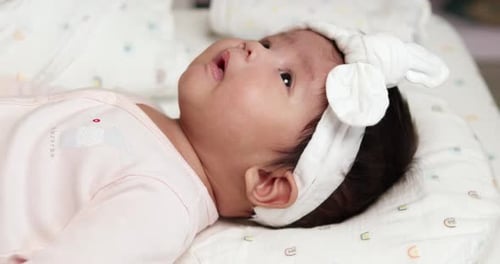 Cute Infant Lying Down on Blanket Indoors