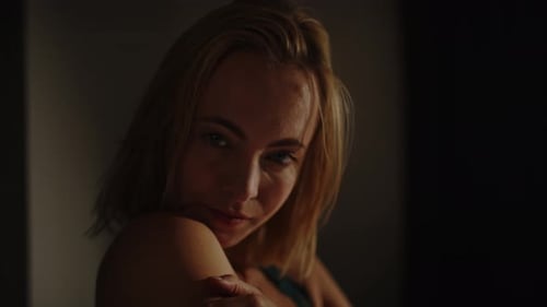 Blonde Woman Alluring Glance, Close-Up Indoor Portrait