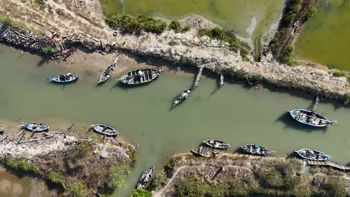 Tranquil River Scene Featuring Abandoned Vessels and Lush Greenery