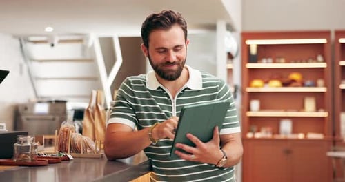 Business owner, man and happy with tablet in cafe for reading website review