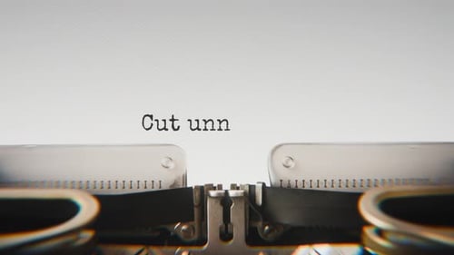 Old mechanical typewriter typing Cut Unnecessary Costs in a close-up view.