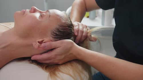 Woman Relaxing During a Calming Head Massage