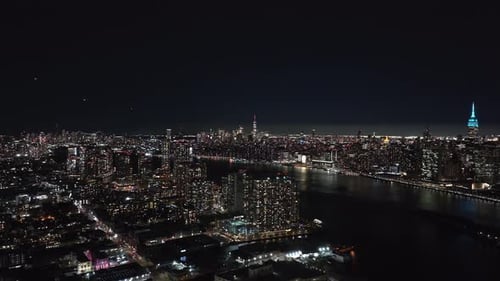 Views of the East River Reveal New York City's Illuminated Skyline at Night Showcasing Vibrant