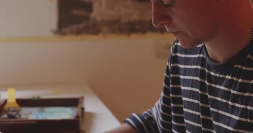 Artist Drawing Sketch at Table Indoors