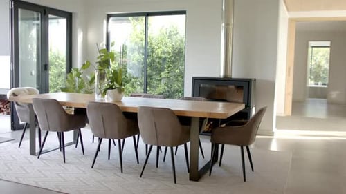 A modern dining area is bathed in natural light