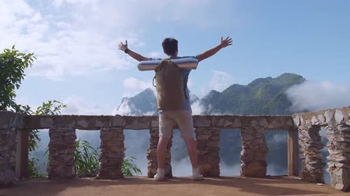 Asian Hiker Male Raising His Hands Celebrating Reaching Up Top Of Foggy Mountain