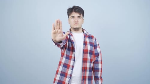 Man making stop sign for camera.