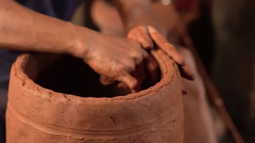Hands Forming Clay on Potter's Wheel