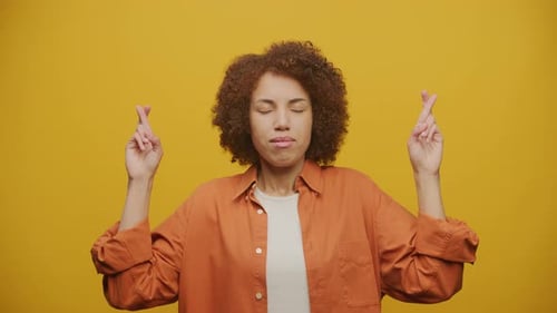 Woman Crossing Fingers Hoping for Good Luck