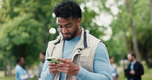 Funny, phone and volunteer man in park for charity, community outreach or donation update