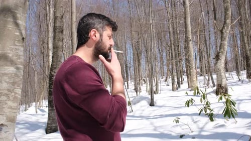 Man Smoking in the Forest