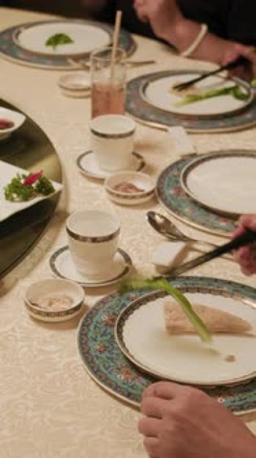 Unrecognizable People Dining Together with Various Dishes in Restaurant