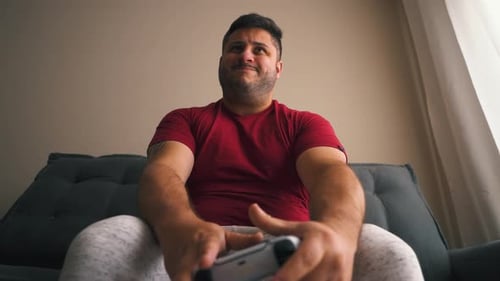 Young Adult Playing Video Games on Couch