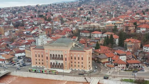 Colorful Tram In Front Of Sarajevo City Hall On The Embankment Of Miljacka River In Bosnia And Herze