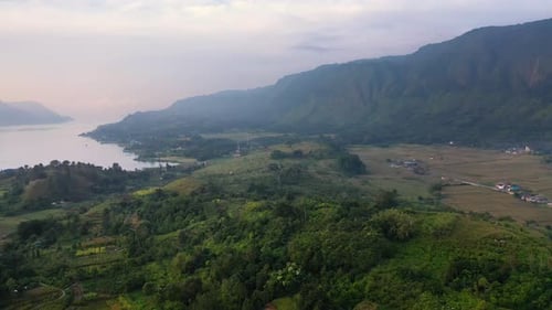 Aerial view of plantations and fields below big hills on Samosir Island in Lake Toba in North Sumatr
