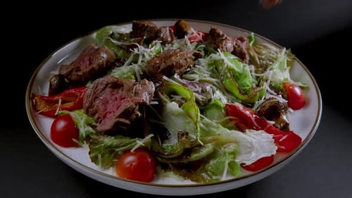 Chef Adding Steak to a Delicious Salad