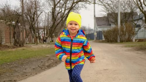Uma criança corre e brinca na rua
