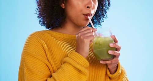 Young Woman Drinks Green Juice Close Up