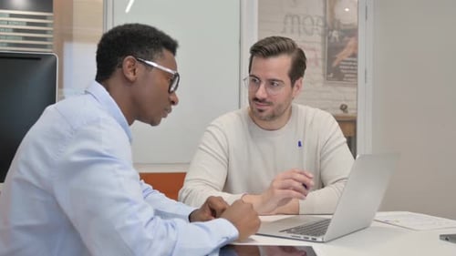 Business People Discussing Project while Sitting in Office