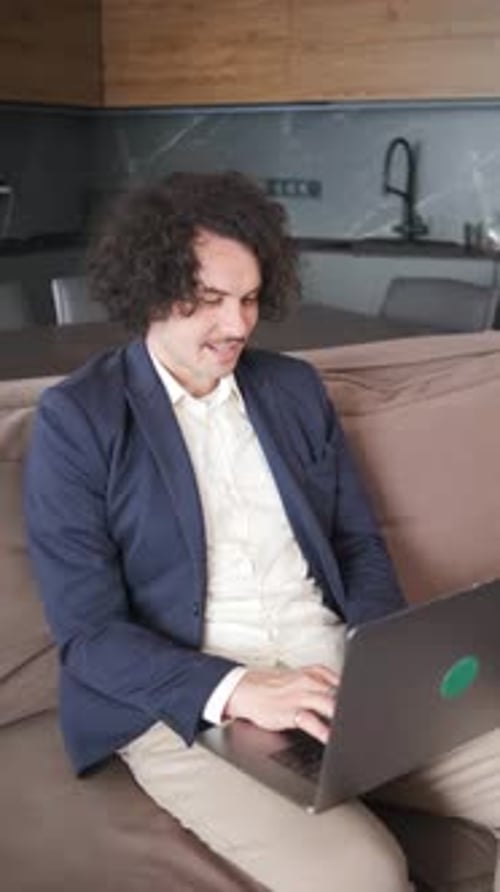 Man Working on Laptop on Couch