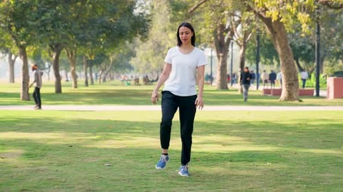 Woman Stretching Legs in a Sunny Park