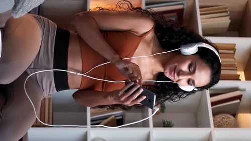 Woman Listening to Music with Headphones Indoors