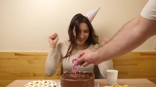 Woman Celebrates Birthday with Cake and Candles