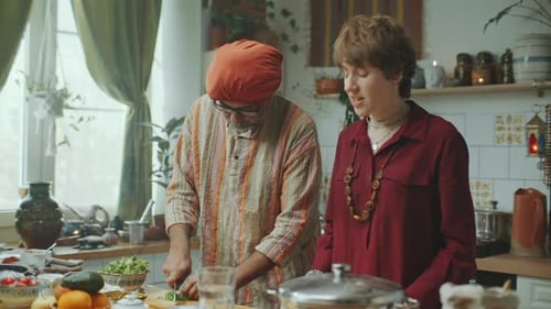 Adults Cooking Together in a Cheerful Kitchen