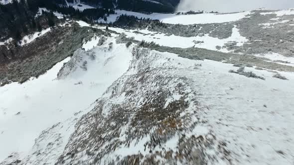Drone steep dive along exposed snowy ridgeline of Hohe Veitsch, Austria ...