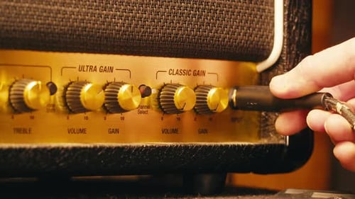 Plugging Guitar Cable Into Vintage Amplifier, Close Up