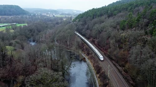 Passenger's Train Passing Through Railway By The Mountain Covered With Dense Forest In Jonsered,