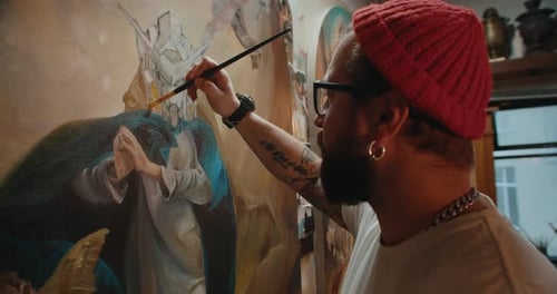 Male Artist Paints a Canvas in His Art Studio