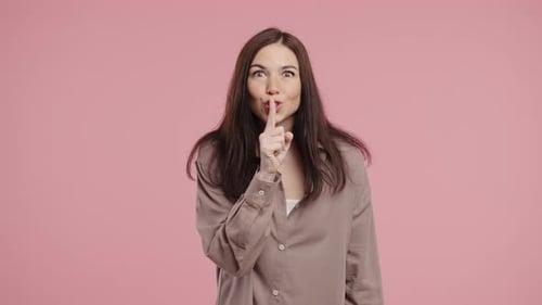 Woman Puts Finger to Lips Asking for Silence