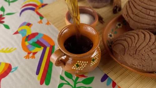 Pouring hot chocolate into a ceramic mug
